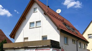 A two-story building with a red-tiled roof and a white facade. - Apartment La Marie (Schwaebisch Gmuend)