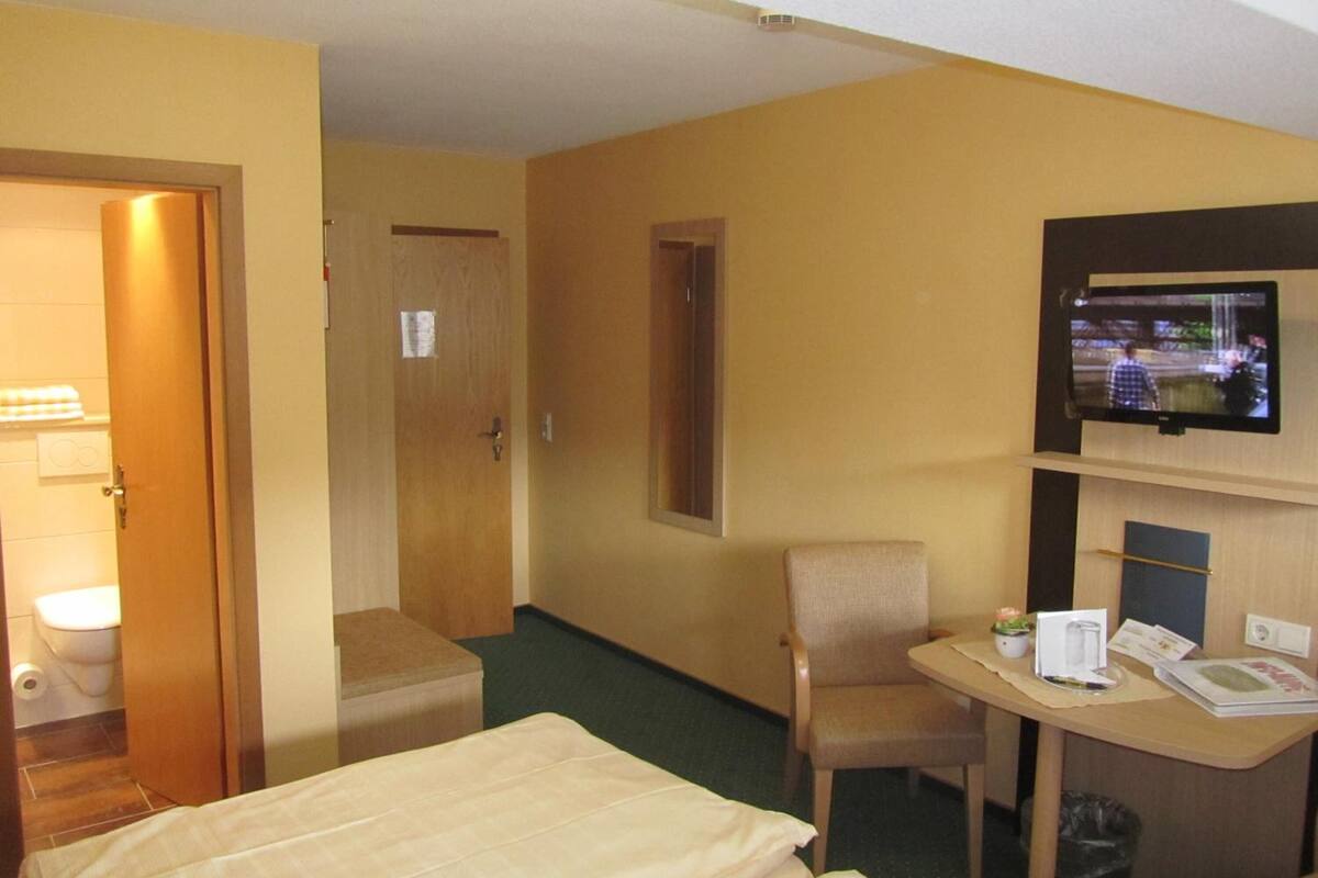 hypo-allergenic bedding, desk, laptop workspace, blackout curtains