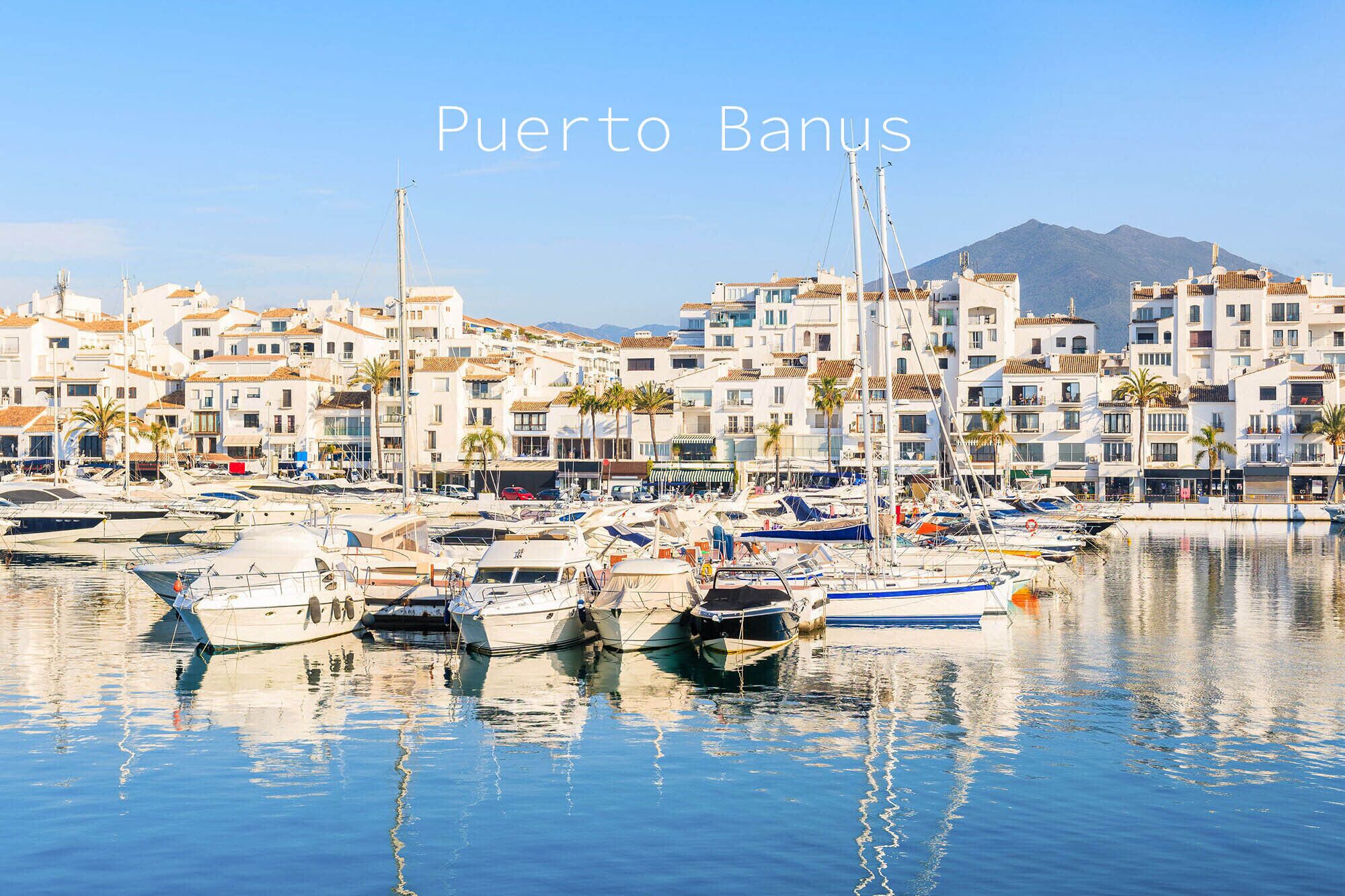 A marina with boats and buildings in Puerto Banús.