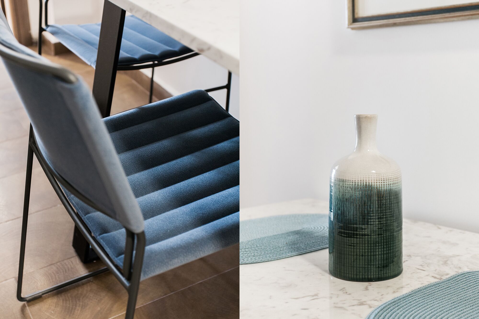 A modern chair with a blue cushion and a tall, narrow vase with a textured pattern on a marble surface.