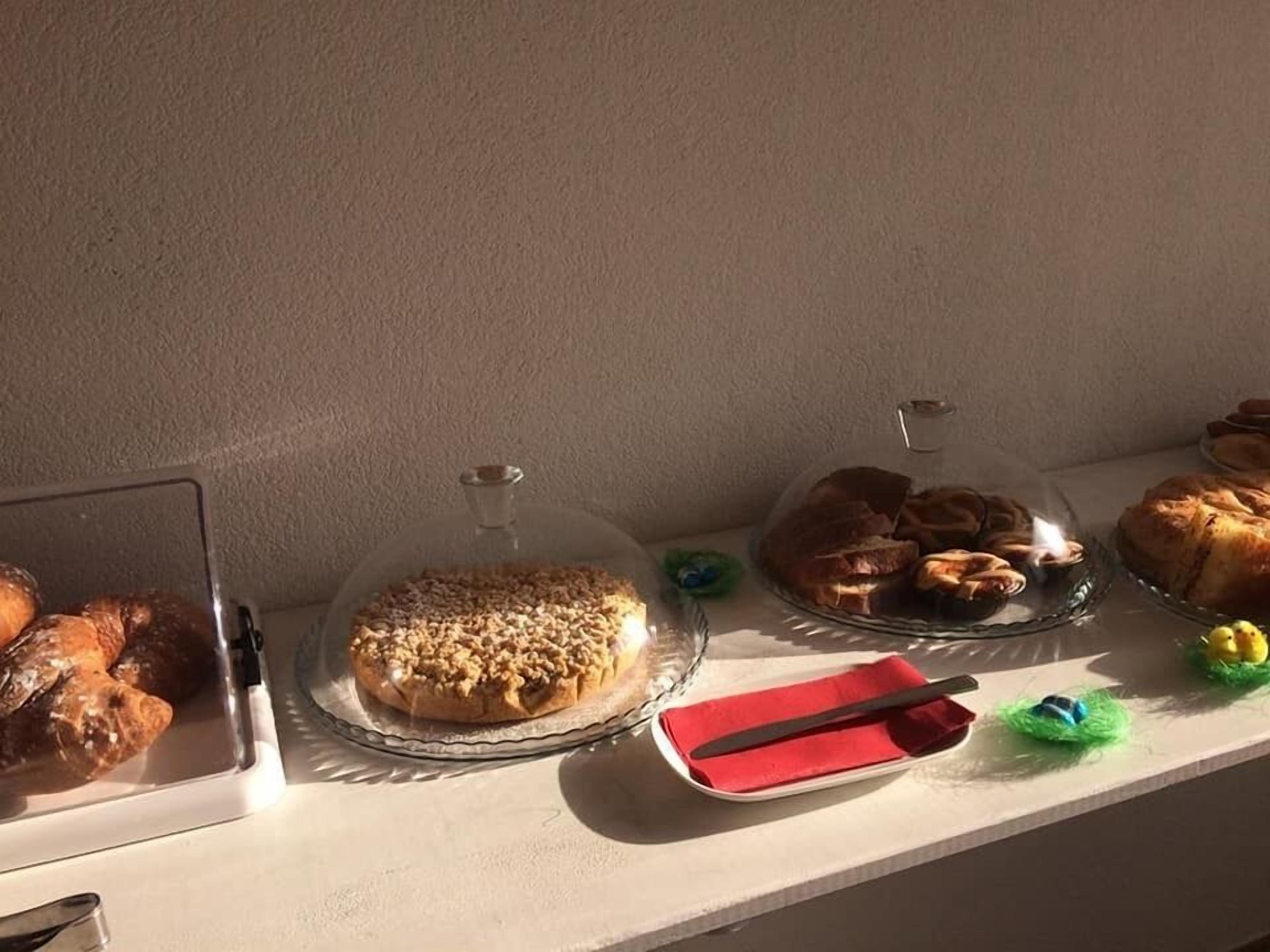 A display of various pastries and desserts on a counter.