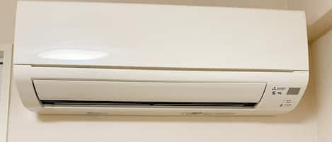 A white air conditioning unit mounted on a wall.