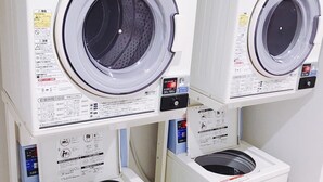 Three stacked front-loading washing machines in a row. - REX INN Namba (Osaka)