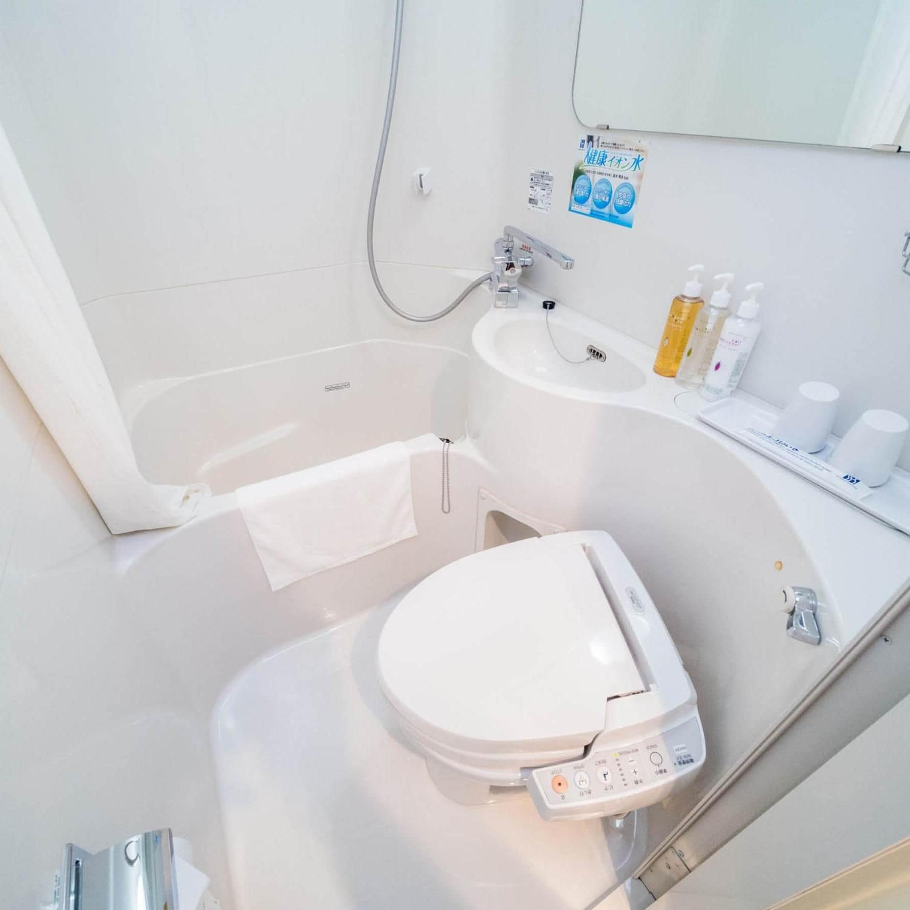 A modern bathroom with a bathtub, sink, and toilet.