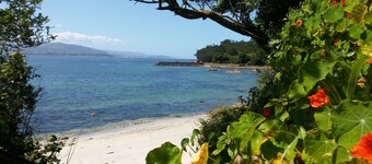 Beachfront villa with private garden and patio and free parking on the street.