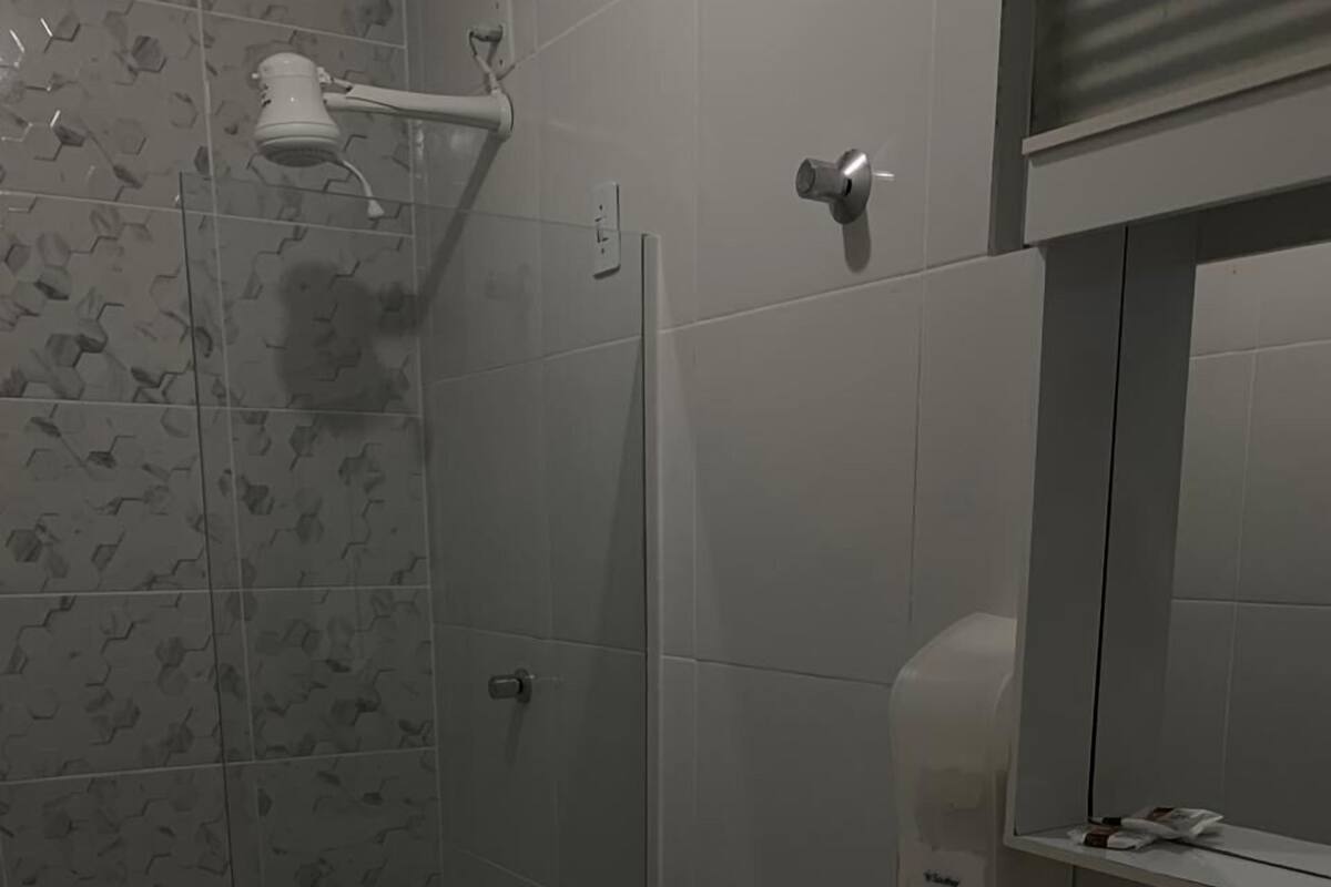 A bathroom with a toilet, bidet, and shower.