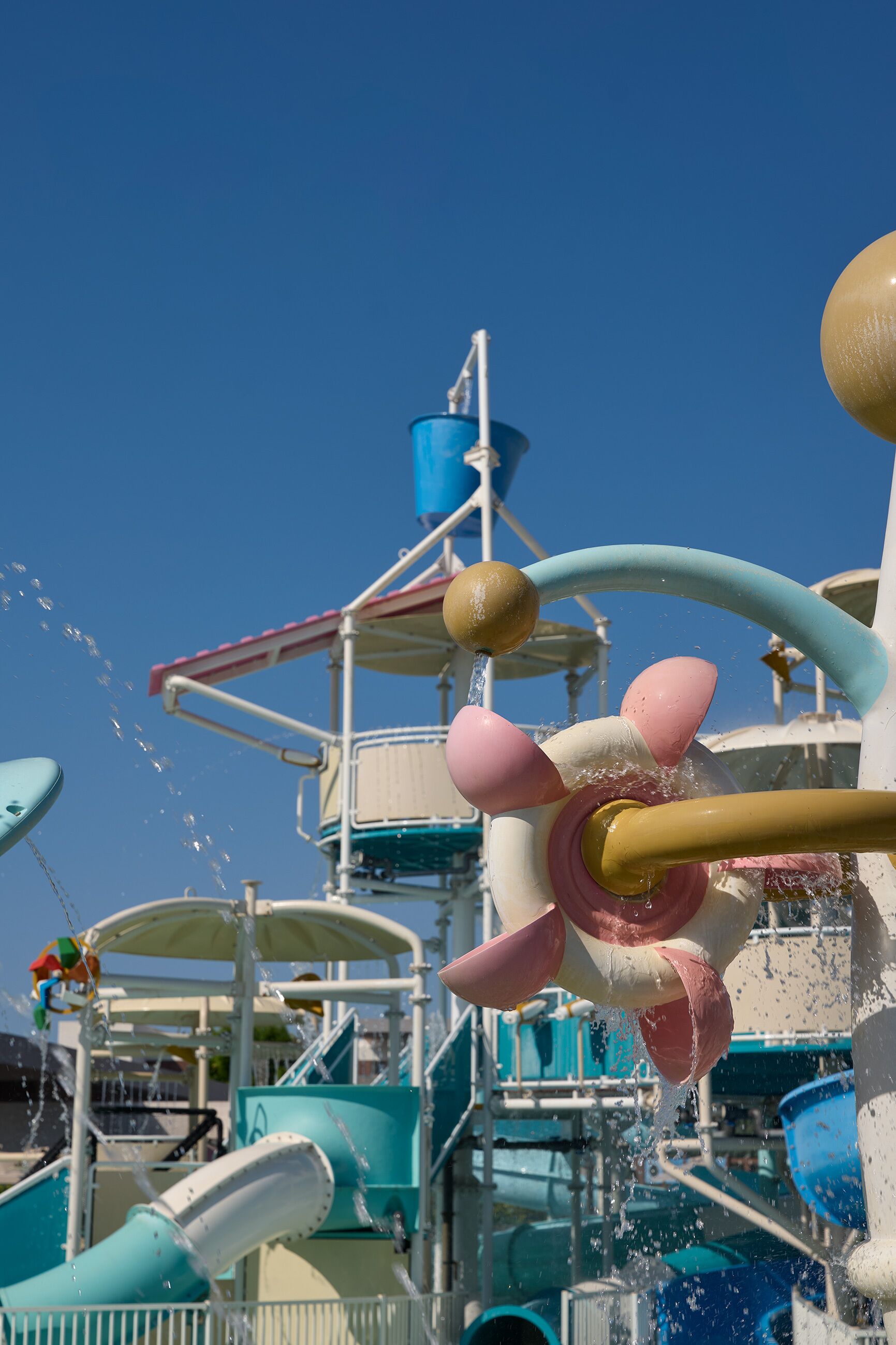 A water park ride with multiple water jets and slides.
