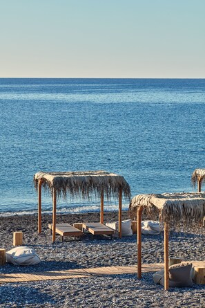 On the beach, sun-loungers, beach umbrellas, beach towels