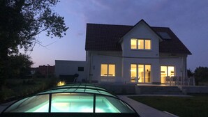 A two-story house with a swimming pool in the foreground. - Dream vacation, luxury and relaxation with your own pool and sauna  (Kalkhorst)