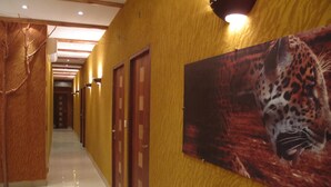 A hallway with wooden doors and a leopard mural on the wall. - Kactus  Lodge (Pointe-Noire)