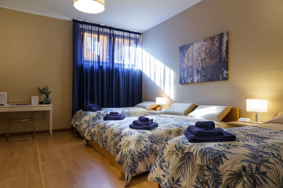 Quadruple Room | Minibar, in-room safe, desk, laptop workspace