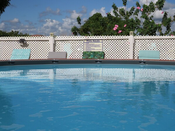 Outdoor pool, open 11:00 AM to 8:00 PM, pool umbrellas