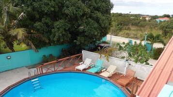 Outdoor pool, open 11:00 AM to 8:00 PM, pool umbrellas