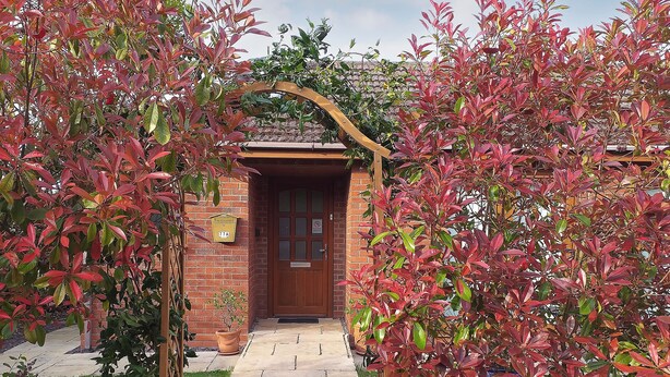 A brick building with a wooden door and a mailbox. - 1 bedroom accommodation in Malvern (Malvern)