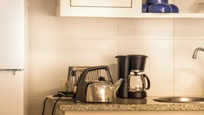 A kitchen with a white refrigerator, a coffee maker, and a kettle on the counter. - Lemon Tree at Terrus Winery (Barrô, Viseu)
