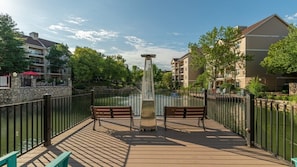 Relax on the deck overlooking the water, surrounded by serene views and comfortable seating.