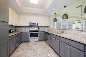 Enjoy cooking in this well-equipped kitchen with a stainless steel range, microwave, oven, and dishwasher.