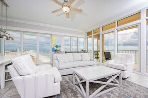 Enjoy a panoramic ocean view from the large window, with ample seating and a clean, minimalist design.