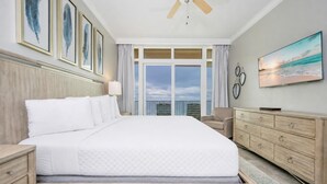 A hotel room with a large bed, a TV, a dresser, and a view of the ocean. - 3 Bedroom 3 Bath *6th floor* LAZY RIVER! Phoenix Orange Beach 605 (Orange Beach)