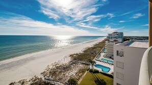A beach view with a swimming pool and a building with multiple floors. - Panoramic Gulf Views 4 Bedroom 7th FLOOR! Phoenix Orange Beach 701 (Orange Beach)