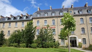 A large stone building with multiple windows and a central entrance.