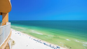 A beach view from a balcony with a clear sky, a sandy beach, and the ocean. - Lazy River + Beachfront  3 Bedroom 3 Bath Phoenix Orange Beach 1905 (Orange Beach)