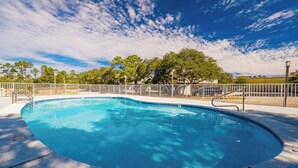 A clear blue swimming pool with a white fence and trees in the background. - Fantastic 2BR Condo - Romar Village 622 (Orange Beach)