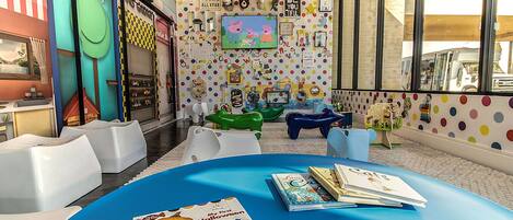A children's play area with colorful furniture and educational materials.