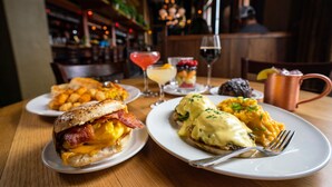 A breakfast setting with a variety of dishes including eggs, toast, and a drink. - McMenamins Elk Temple (Tacoma)