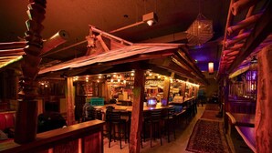 A cozy bar area with wooden beams, a counter, and seating. - McMenamins Elk Temple (Tacoma)