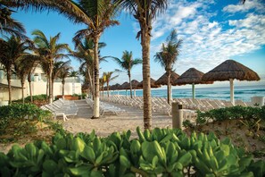 On the beach, white sand, beach umbrellas, beach towels