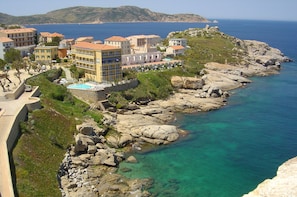 A coastal hotel with multiple buildings, a swimming pool, and rocky terrain. - Penthouse T6 130 m2 duplex terraces 120m2 exceptional sea view Calvi ctre (Calvi)