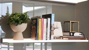 A bookshelf with books and a potted plant.