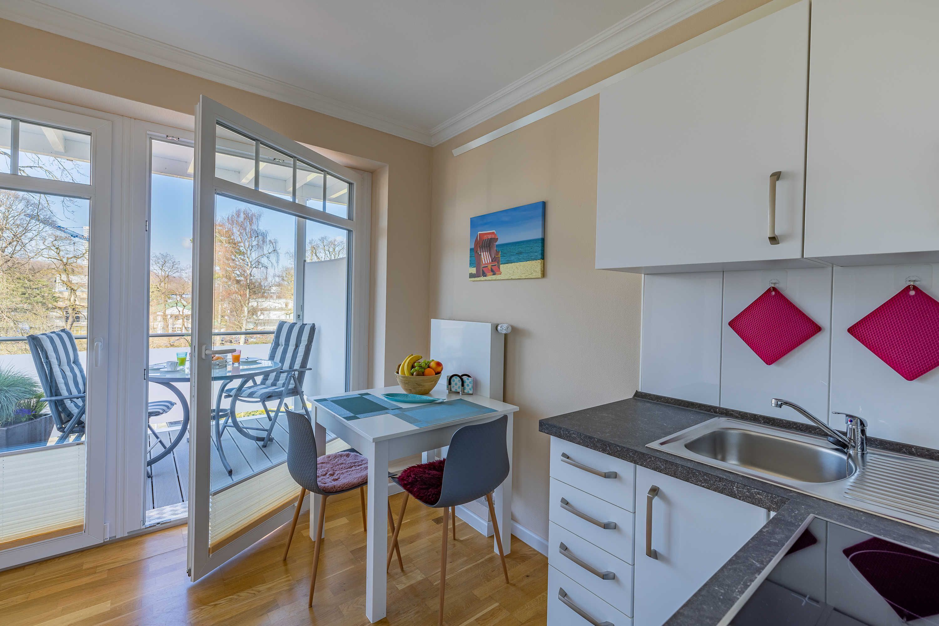 Una cucina moderna con zona pranzo, ampie finestre e vista sull'esterno.