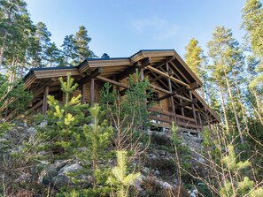 A wooden cabin with a sloped roof, surrounded by a forest. - Roopenranta by Interhome (Asikkala)