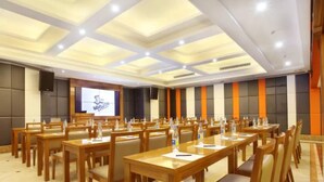 A conference room with multiple tables and chairs, equipped with water bottles and nameplates. - Bolailitai Hotel (Foshan)
