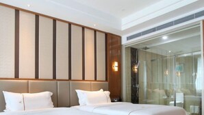 A hotel room with two beds, a large mirror, and a glass shower enclosure. - Bolailitai Hotel (Foshan)