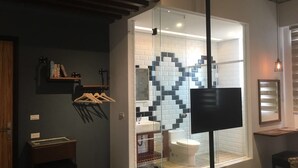 A modern bathroom with a glass partition, a white sink, and a toilet. - Peng Hu 616 B&B (Magong)