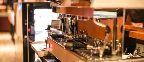 A coffee machine with a digital display and a steam wand.
