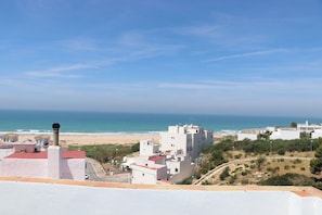 A coastal view with buildings, a beach, and the ocean.