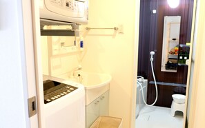 Combined shower/tub, free toiletries, hair dryer, slippers