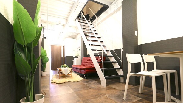 A modern interior with a staircase, seating area, and a large potted plant. - Elizabeth Garden Kuromon (Osaka)
