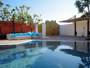 A swimming pool with a wooden deck, a blue cushioned seating area, and a wooden gate. - 866 Oceanic View Villa (Hengchun)