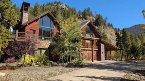 A rustic cabin with large windows, a stone chimney, and a wooden deck. - Custom Keystone Retreat – Summer Events/Hot Tub (Keystone)