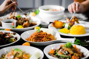 A variety of dishes on a table, including spaghetti, rice, and salads. - Malagos Garden Resort (Davao)