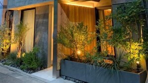 A modern multi-story building with large windows and warm lighting. - Sakura Cross Hotel Tokyo Kayabacho (Tokyo)