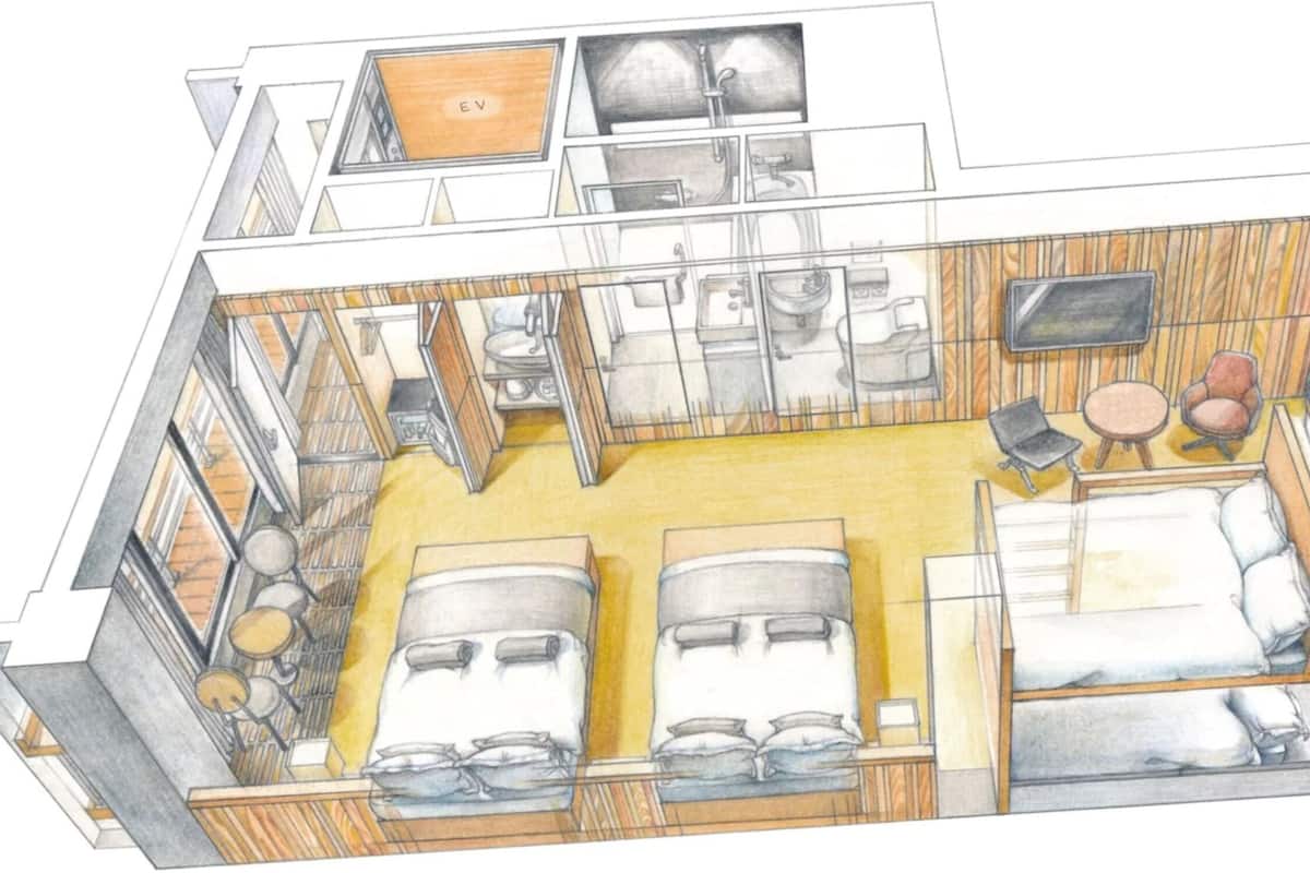 A floor plan of a hotel room with two beds, a sitting area with a table and chairs, a kitchenette, and a bathroom.