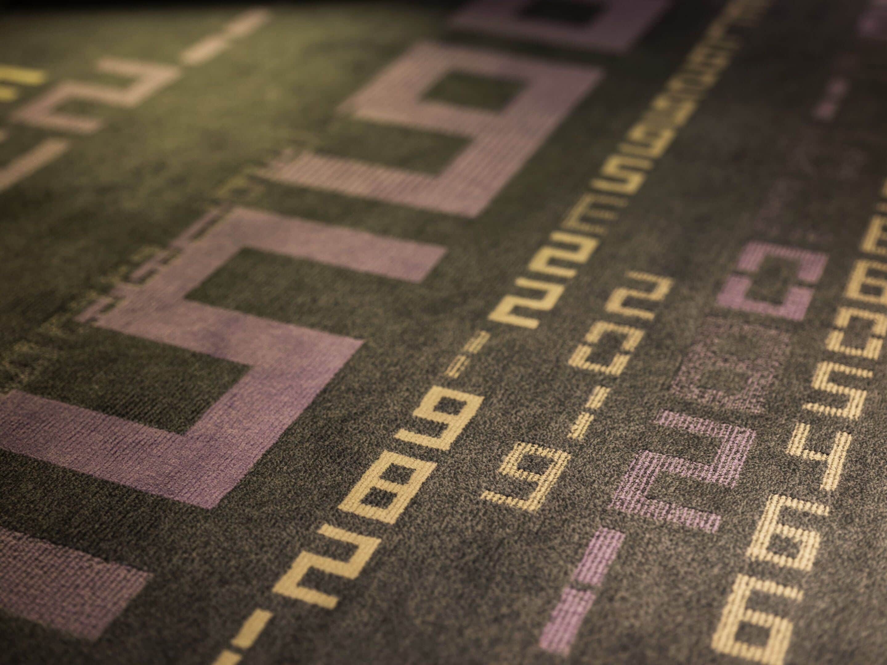A close-up of a carpet with a geometric pattern and numbers.