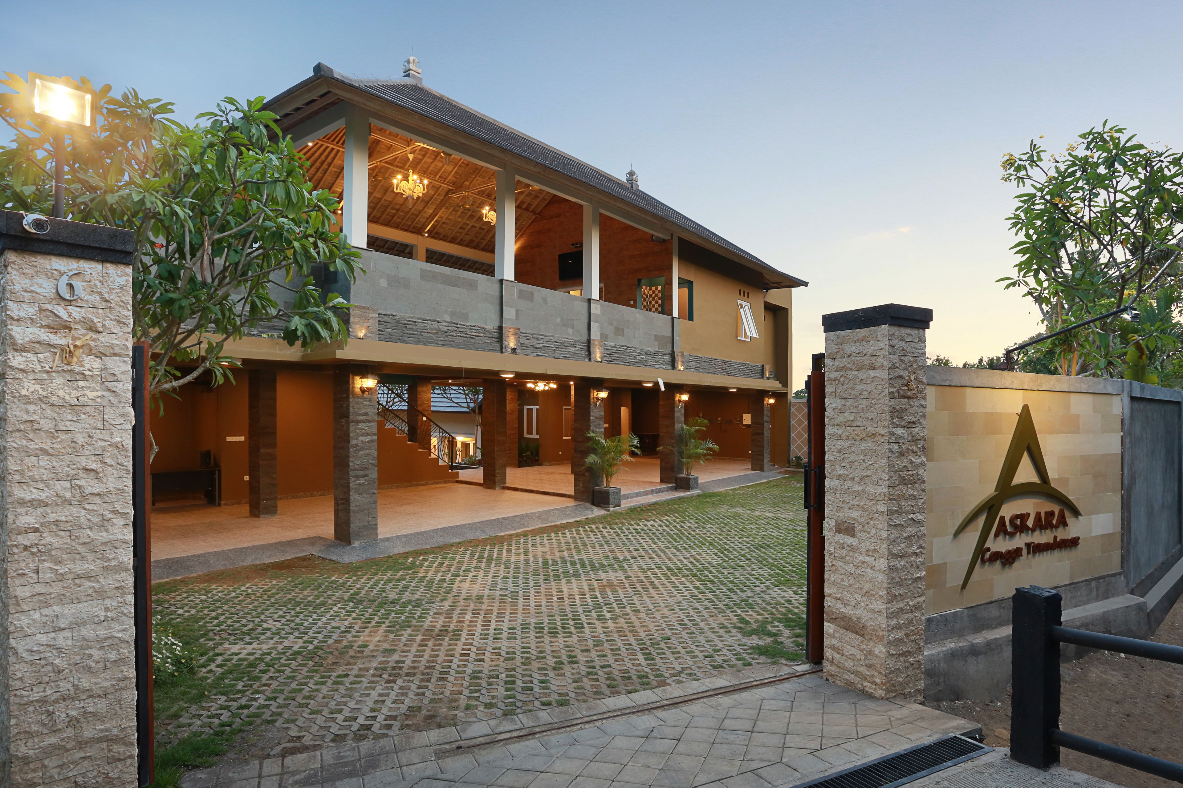 A two-story building with a stone facade, a balcony, and a sign reading "ASKARA Country Retreats".