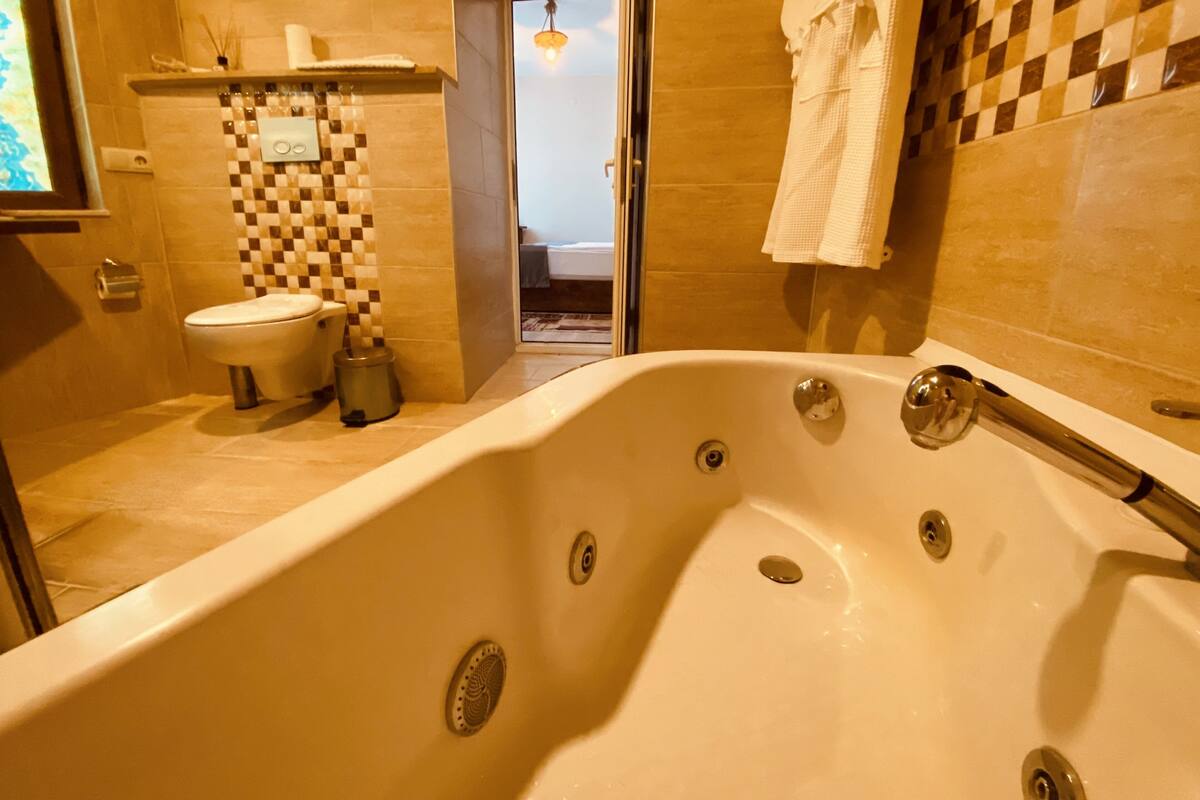 A bathroom with a bathtub, toilet, and sink.
